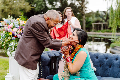 a man putting a hand on a woman's face during a wedding