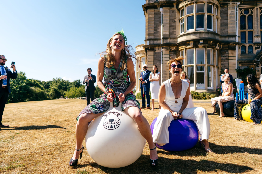 Guests bounding on space hoppers in the gardens of Clevedon Hall