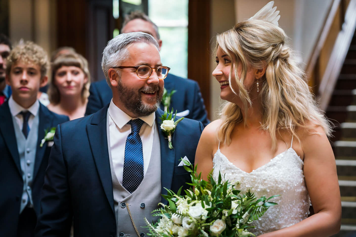 A happy wedding couple doing their wedding ceremony in the Great Hall of Clevedon hall.