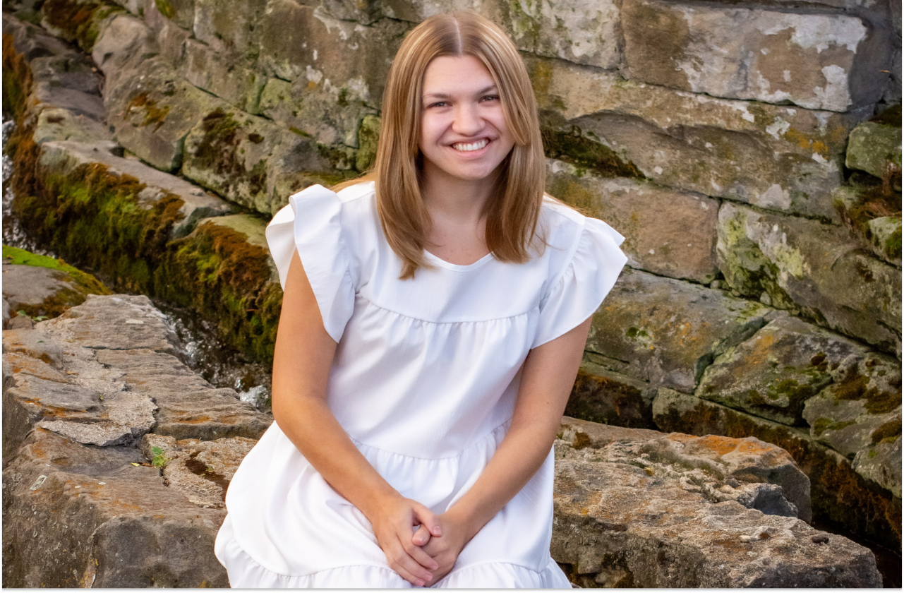 Sophia smiling in front of a wall