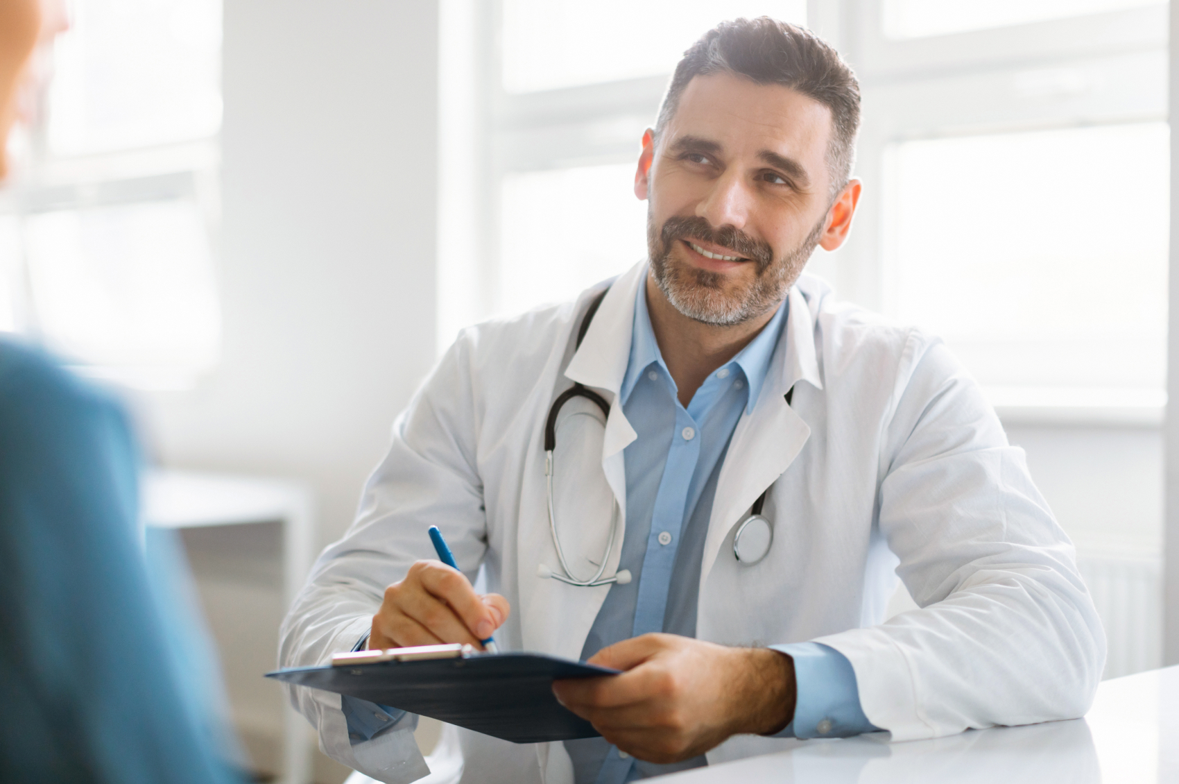 Male doctor talking to patient about neuromodulation devices