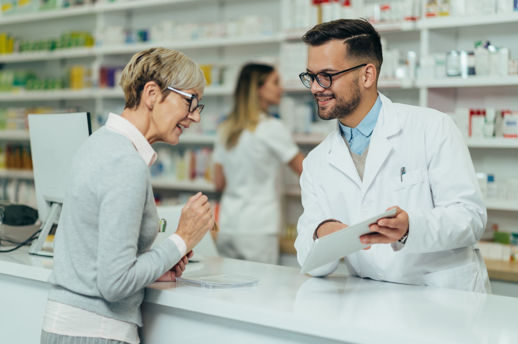 A woman discussing emergency seizure medication with a chemist