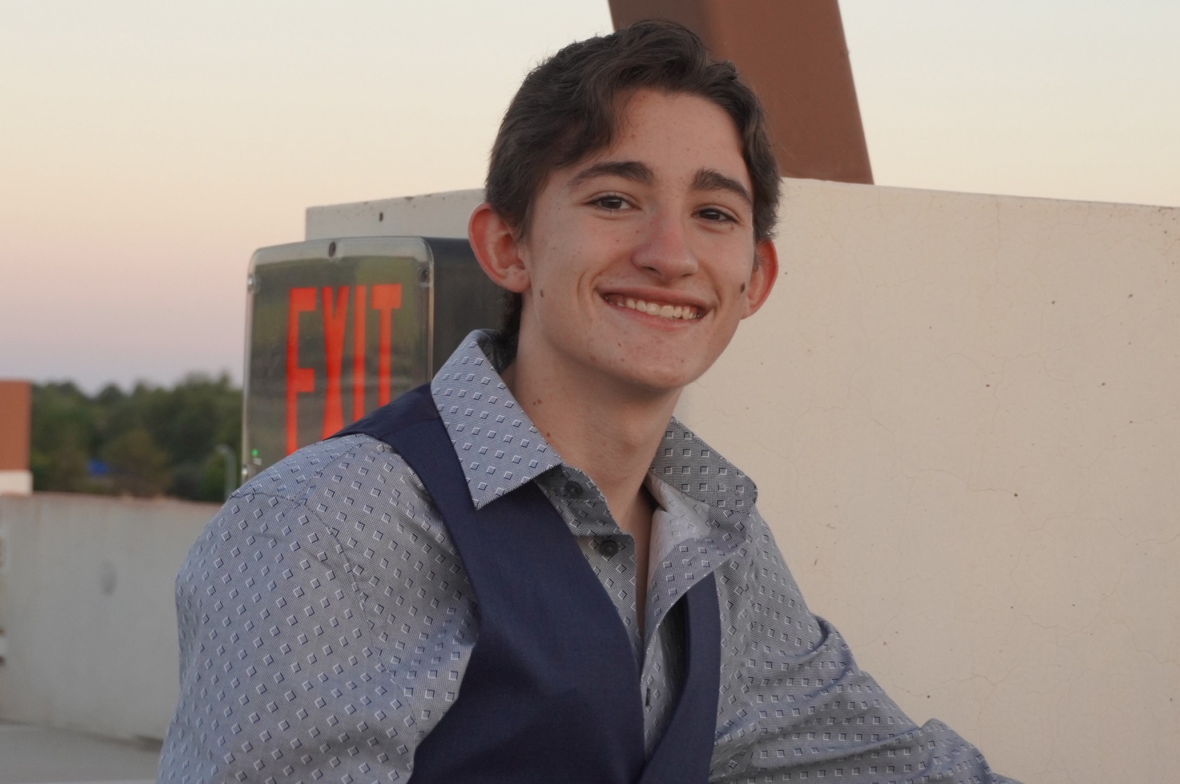 Oli living with epilepsy and smiling in the sun