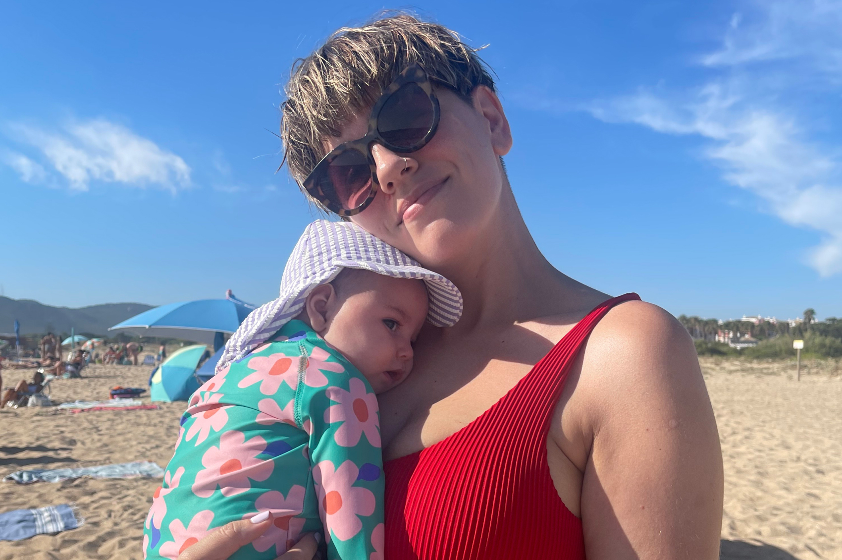 Baby Astrid in mum Sarah's arms at the beach