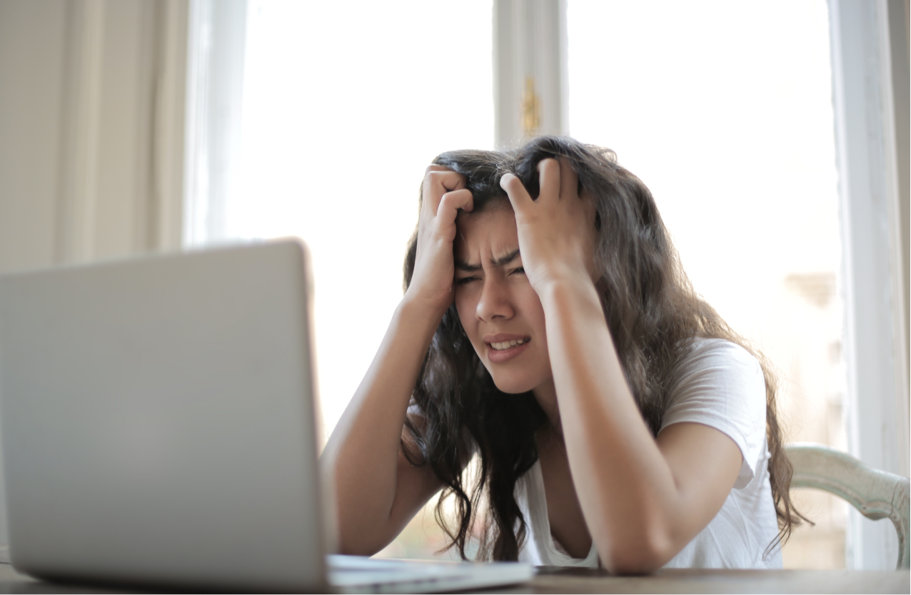 A stressed woman looking at her computer