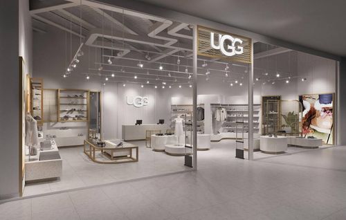 Cozy and stylish UGG boutique featuring a wide selection of winter boots and shoes displayed on modern shelving.