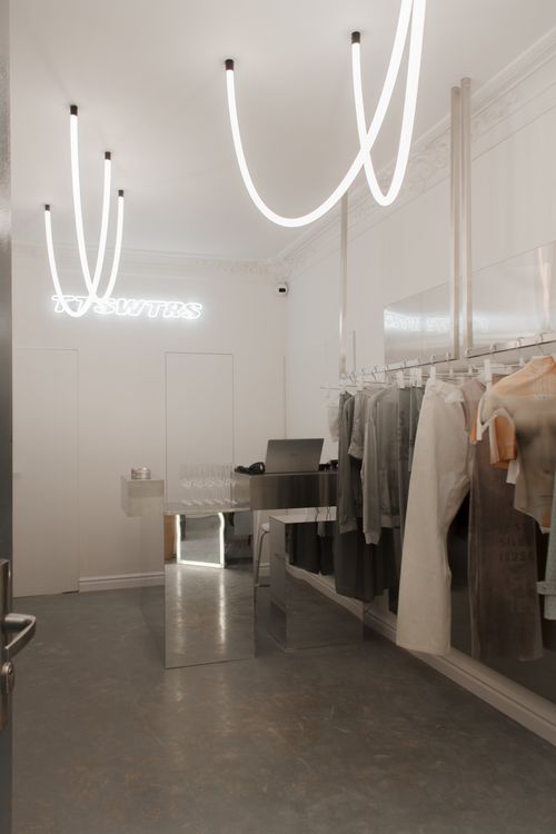 Sophisticated and minimalist boutique in Warsaw with a modern, grey-and-white palette and stylish displays.