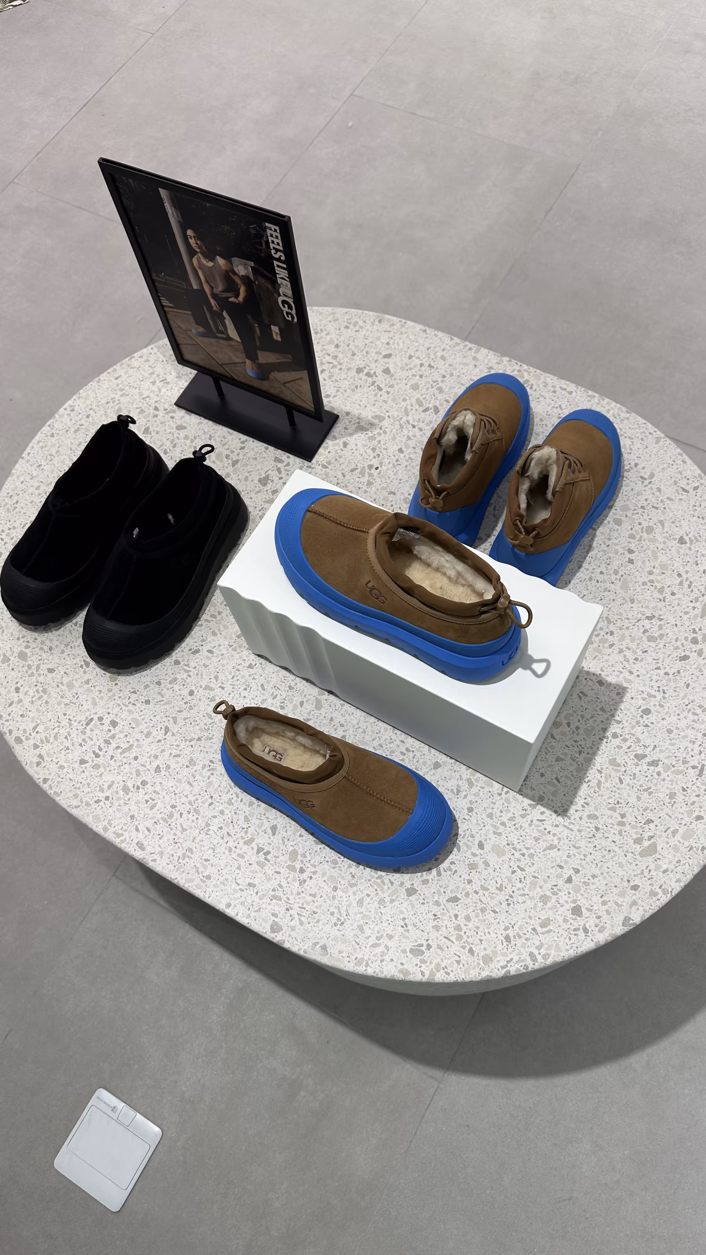 Sophisticated UGG store with a range of winter shoes, displayed in a minimalistic setting that reflects the brand’s cozy yet stylish appeal