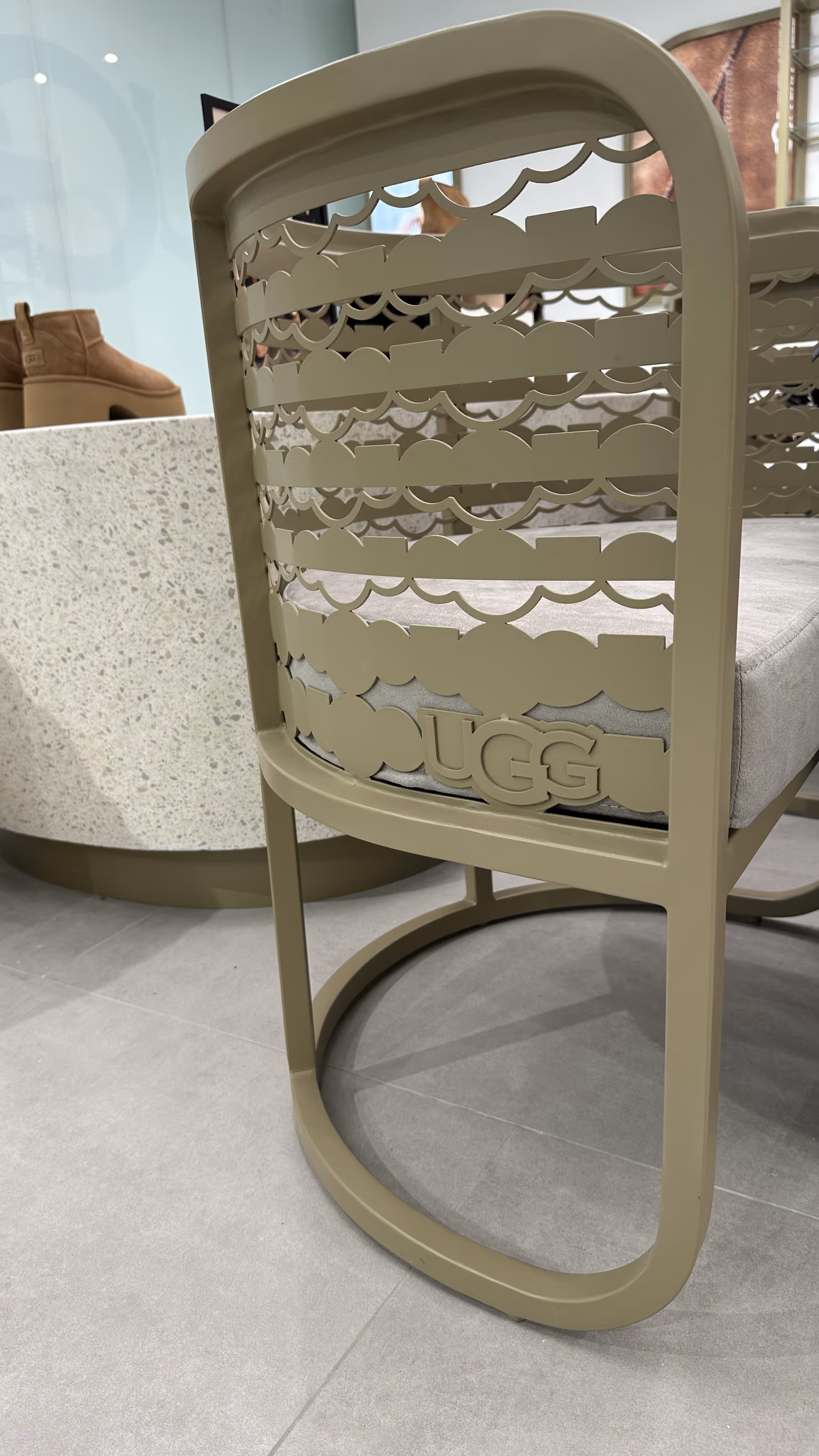 UGG boutique with a warm, inviting atmosphere, showcasing their signature winter boots and slippers in a sleek, contemporary display