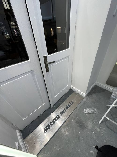 Stylish Warsaw boutique with a minimalist design, grey accents, and vibrant pops of color showcasing the latest fashion.