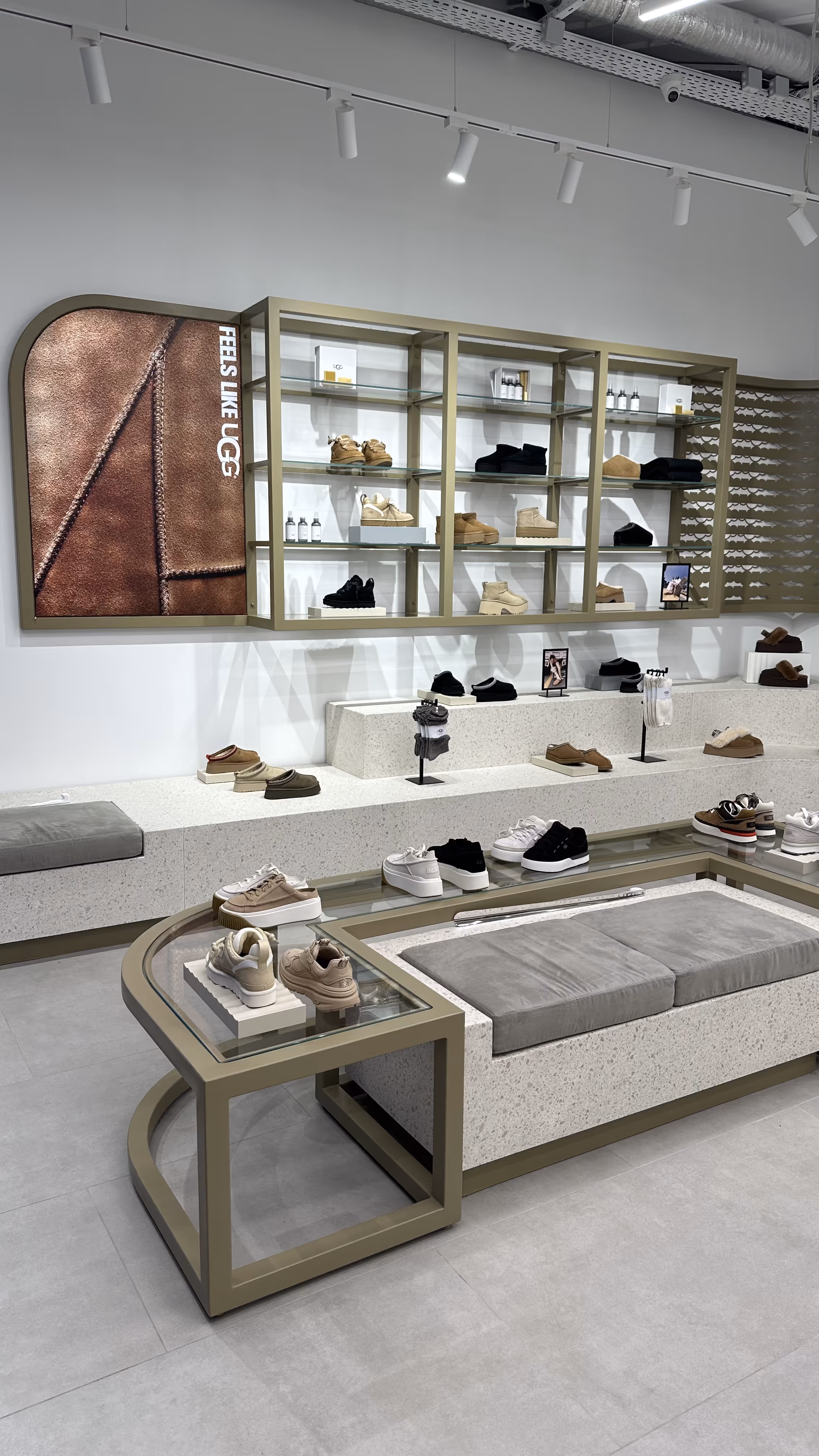 Modern UGG boutique filled with plush winter footwear, featuring neutral-toned shelves and ambient lighting for a comfortable shopping experience.