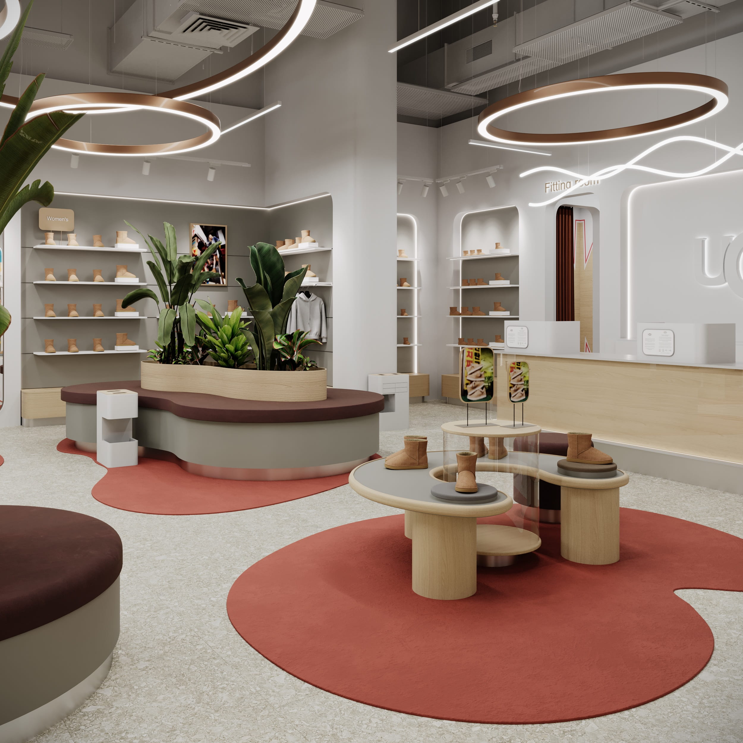 Торговий зал магазину UGG з чітким зонуванням, круглими острівними столами та м’яким освітленням.