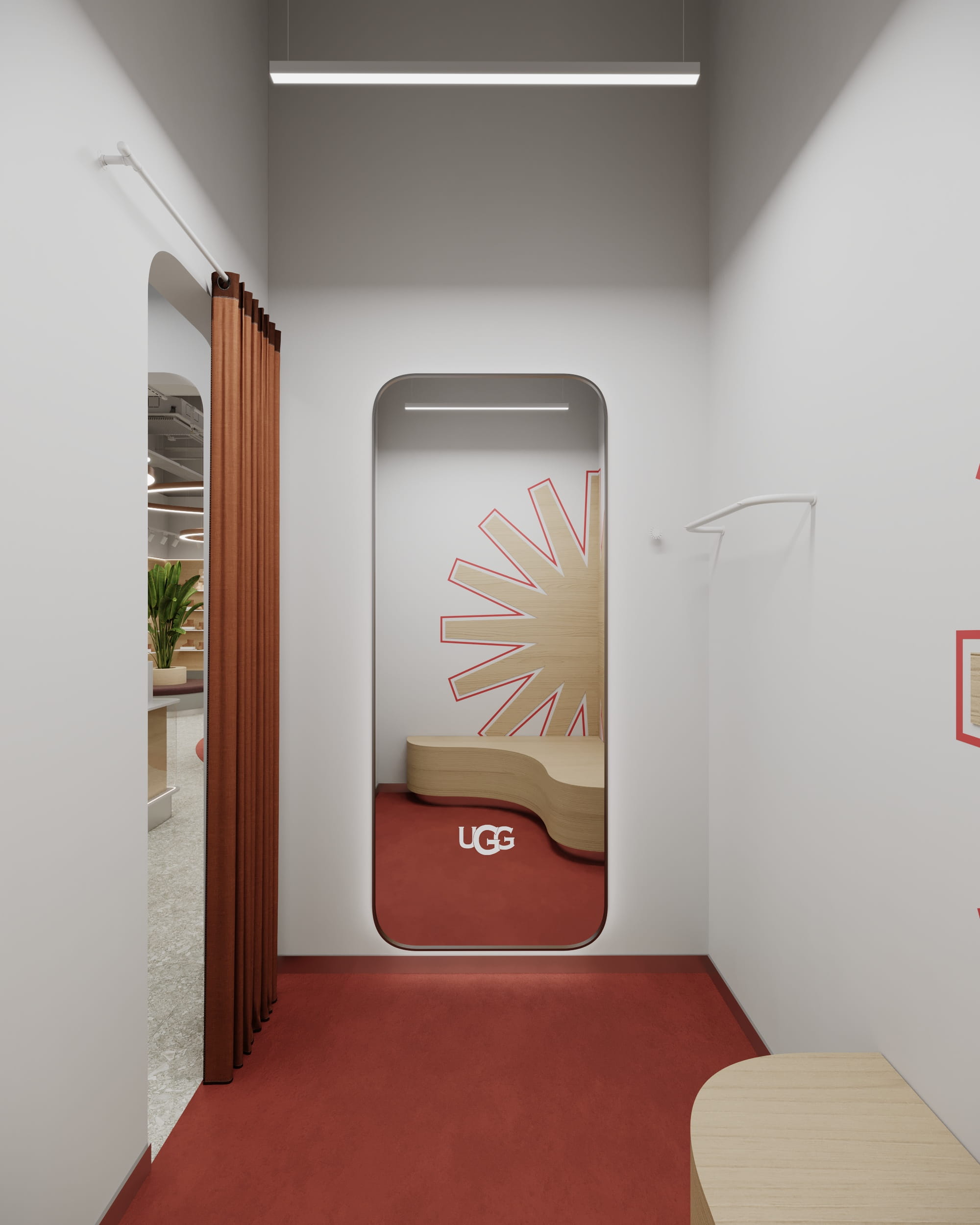Примірочна магазину UGG з графічною стіновою панеллю та м’яким освітленням.