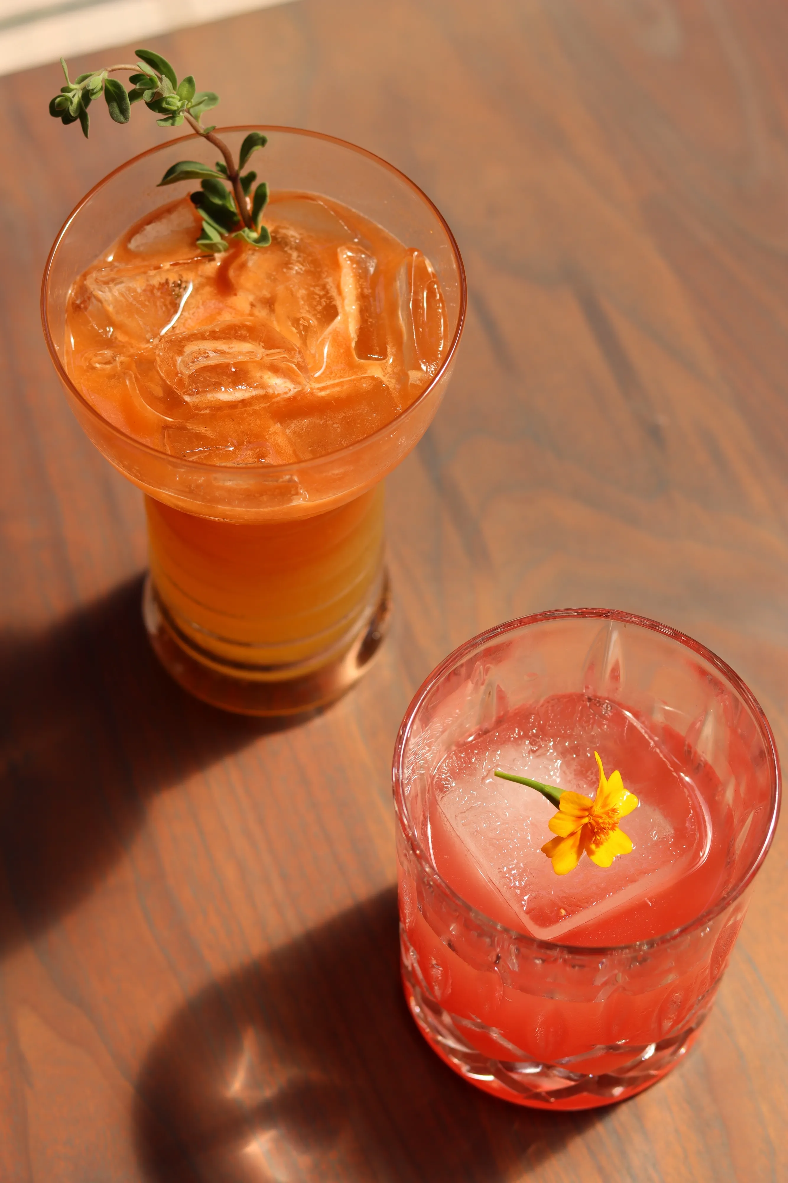 Two vibrant mocktails with garnishes, served at Juanita and Maude restaurant in Albany, showcasing colorful and refreshing drinks