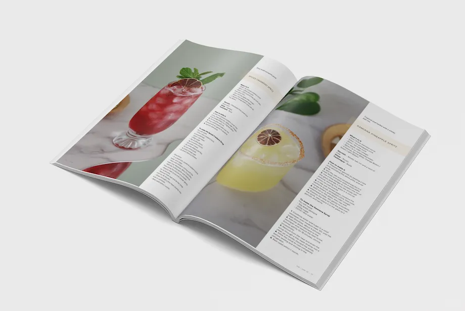 Low no drinker magazine with mocktail images and recipes inside open magazine.