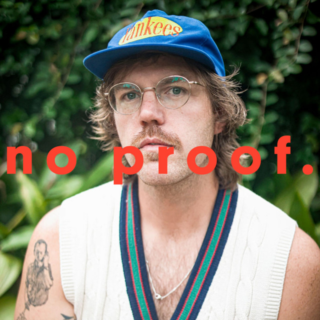 man with glasses and hat with words no proof over the top
