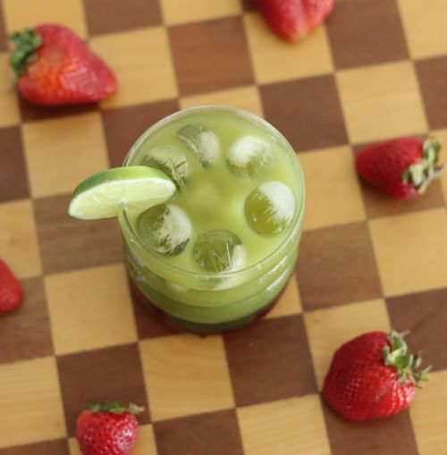 Matcha strawberry mocktail garnished with lime on checkered background made during corporate mocktail mixology class
