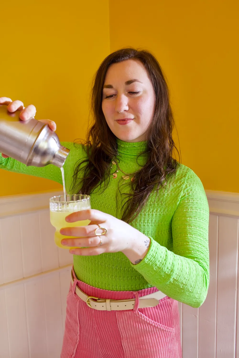Salt-rimmed glass with lime garnish and a green herbal mocktail made during a non-alcoholic mocktail workshop