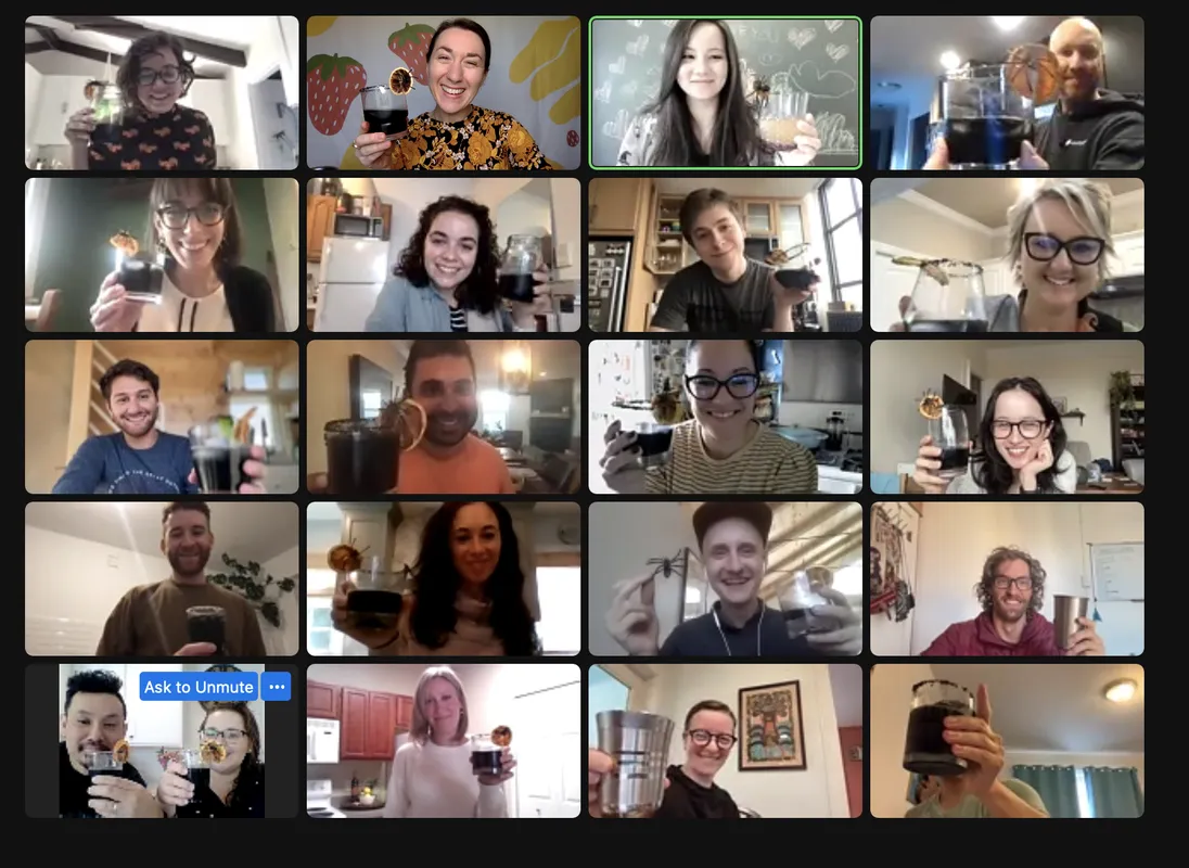 Screenshot of a virtual workshop over zoom, people smiling with mocktails