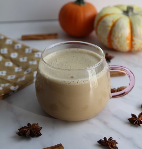 Pumpkin spiced latte served in a glass cup, created during a corporate team-building workshops with a cozy, seasonal twist