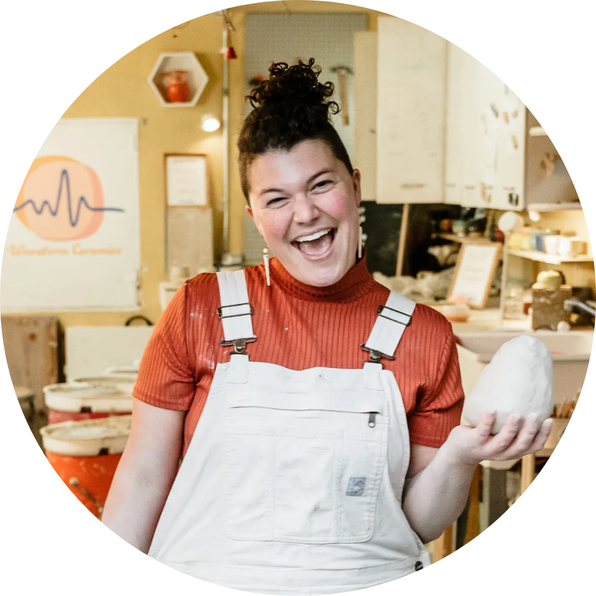 Person holding clay and smiling during corporate team building activity