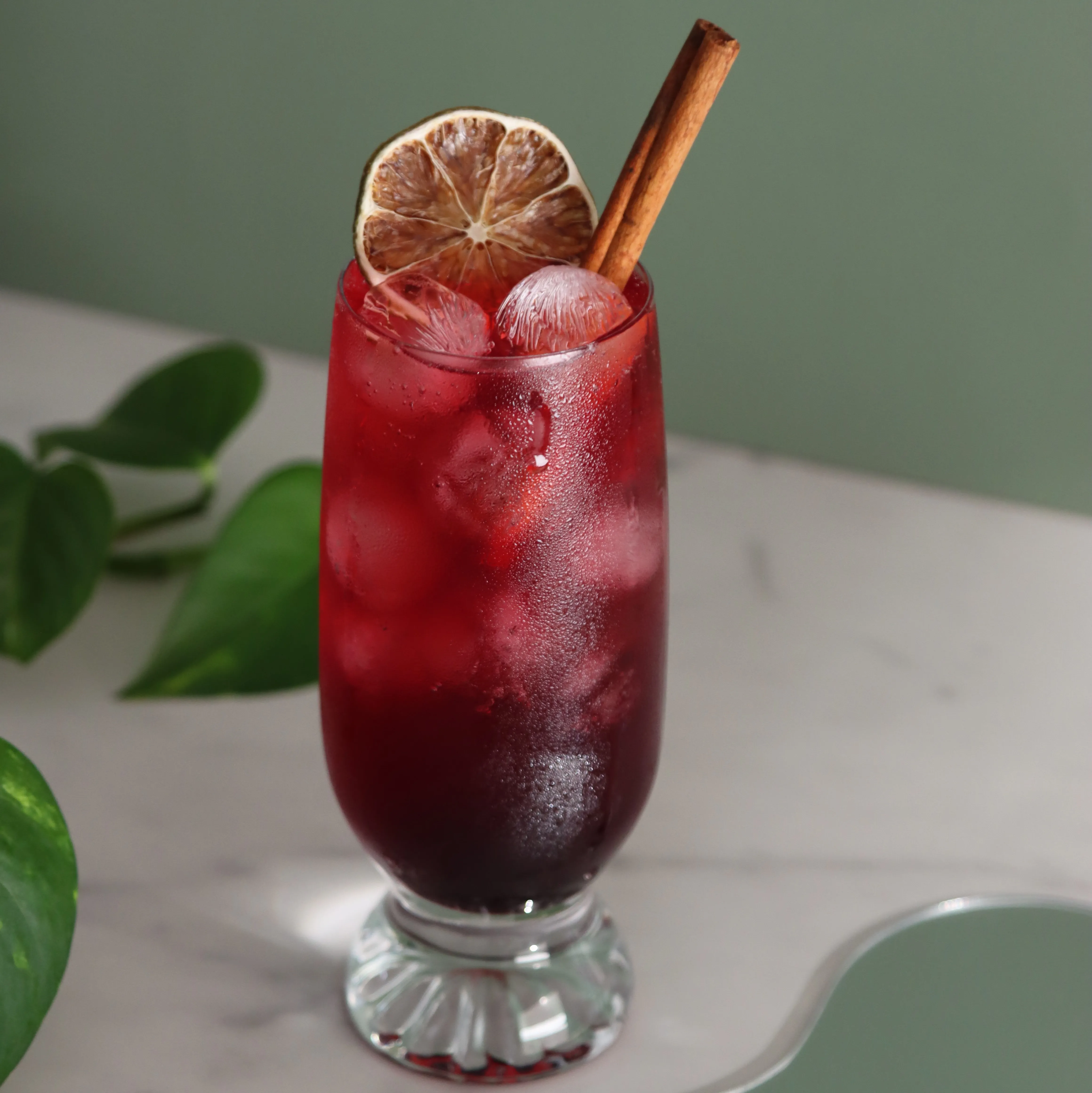 Blackberry mocktail on green background made during dry january virtual class