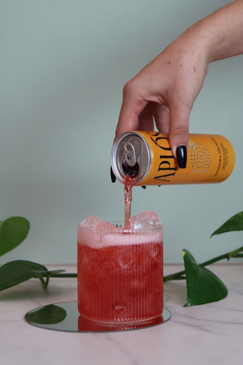 Hand pouring adaptogenic mocktail during corproate event