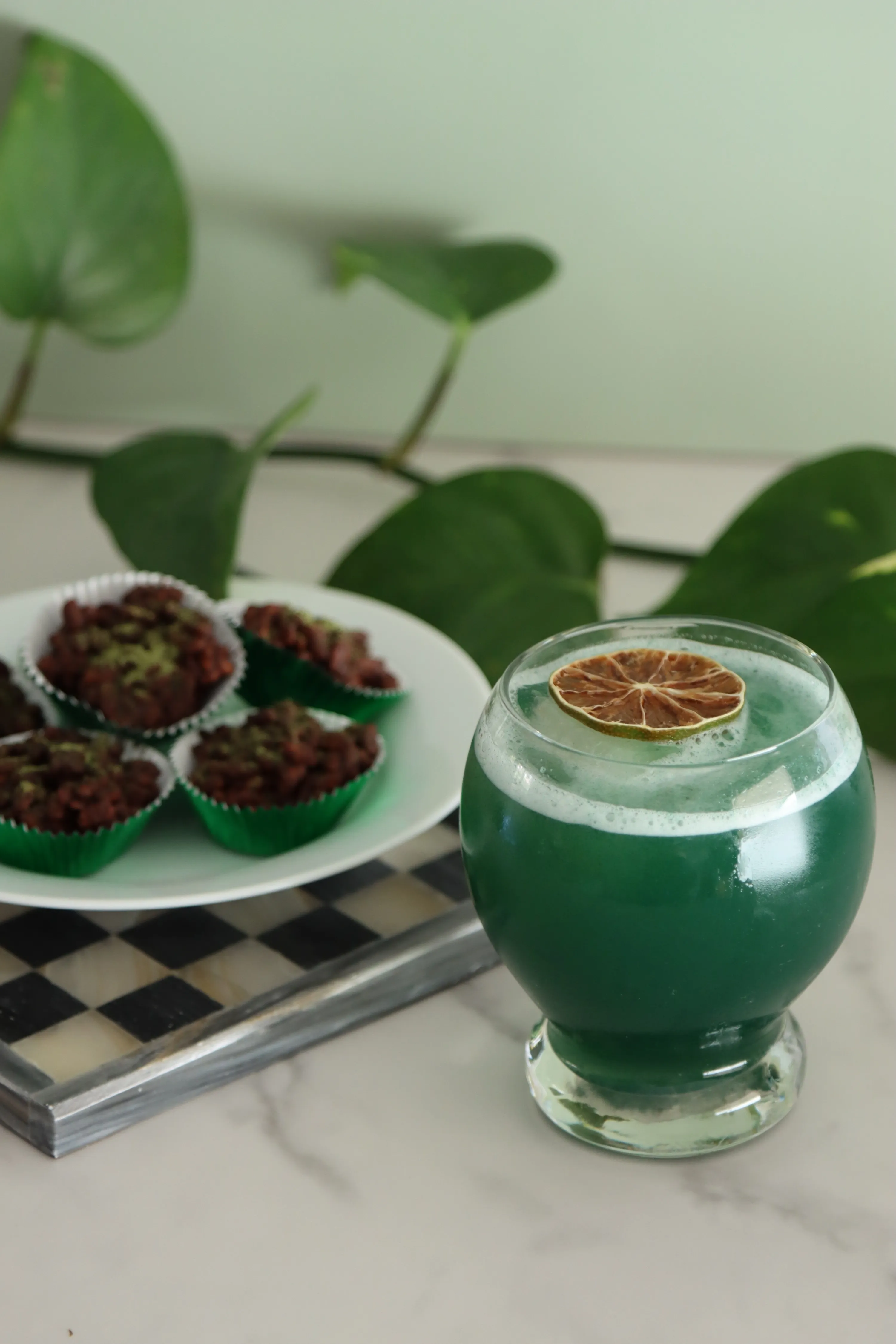 Shamrock Sour mocktail on checkered tray with lime and cherry garnish made for corporate St. Patrick’s Day and mixology workshops