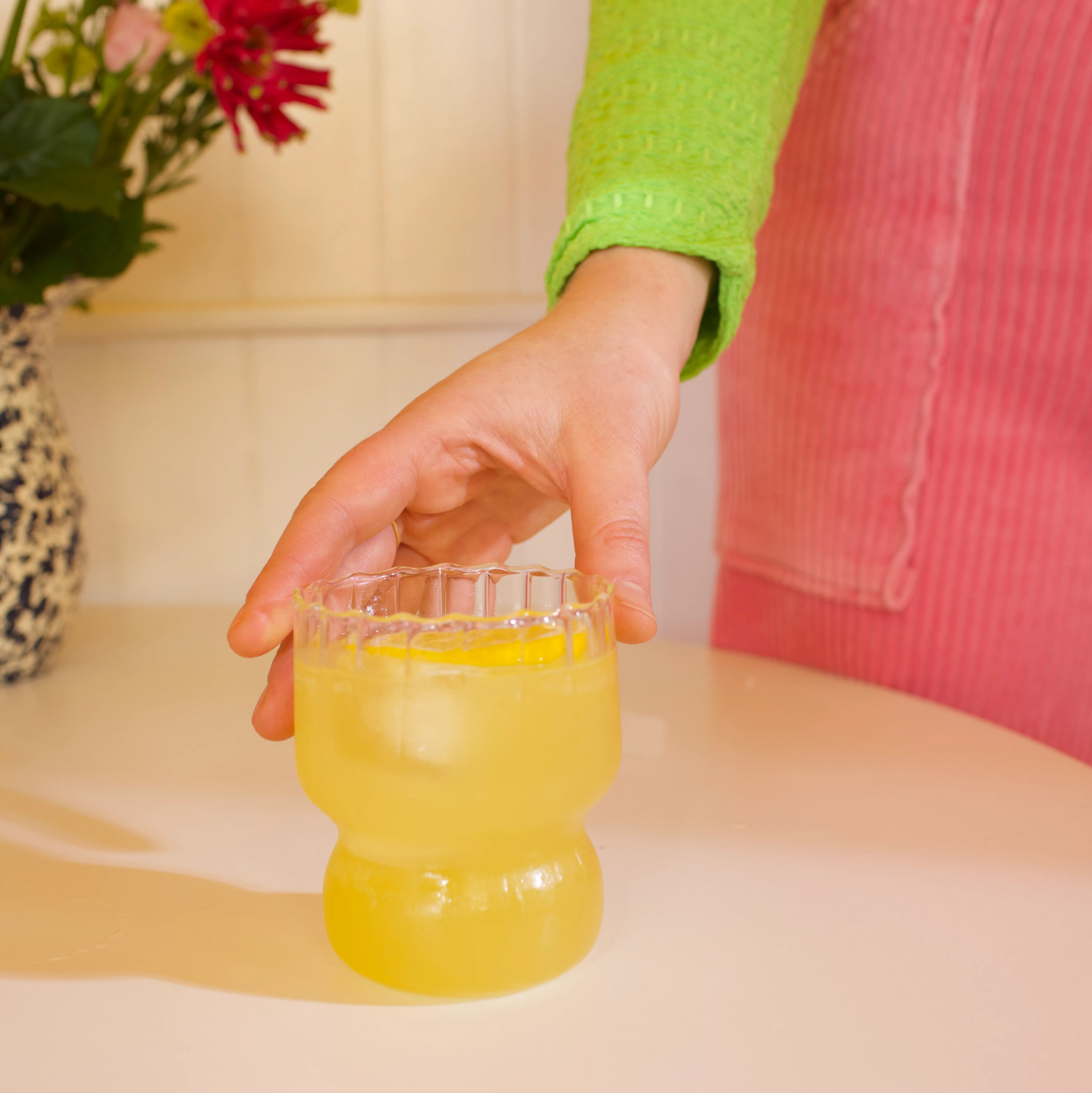 Zero waste lemonade on table with hand holding cup