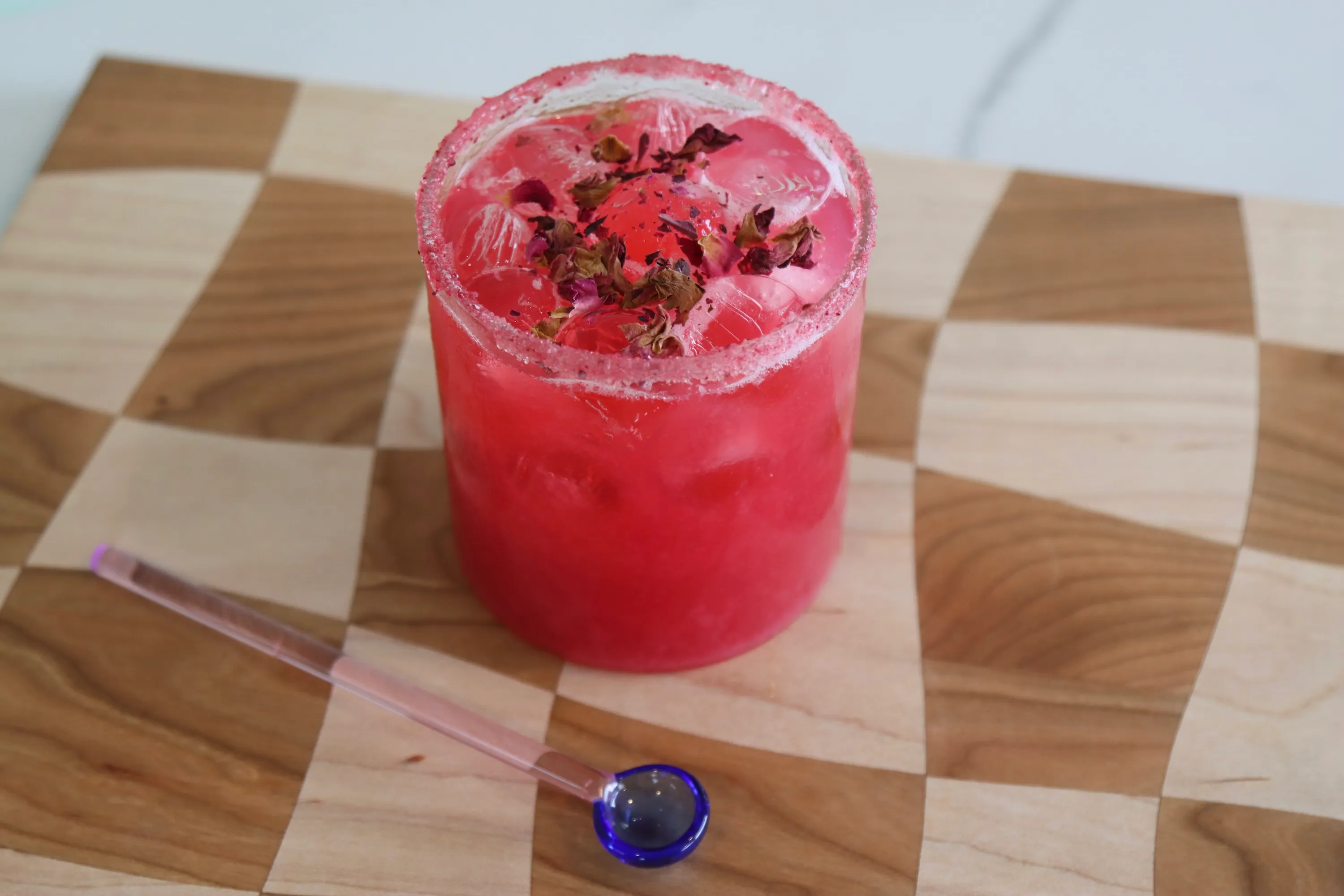 pink non-alcoholic cocktail on checkered board