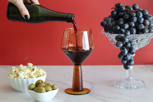 Hand pouring non-alcoholic wine during corporate wellness event