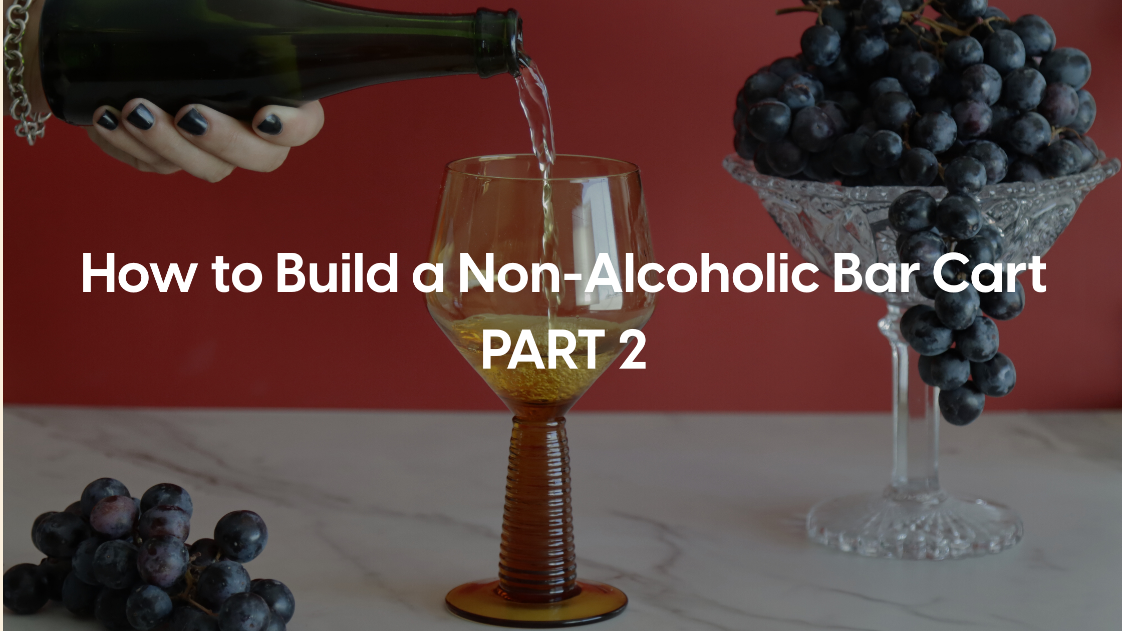 Hand pouring non-alcoholic wine from non-alcoholic bar cart with words : How to Build a Non-Alcoholic “Bar Cart” part 2