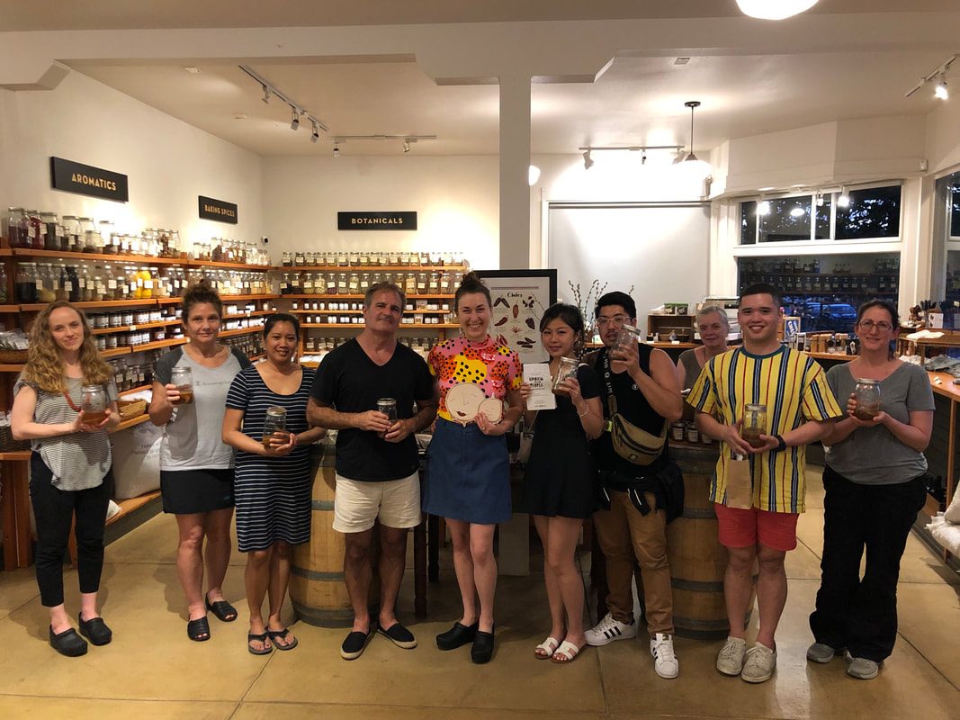 group of people smiling at oaktown spice shop after kombucha to the people kombucha brewing workshop