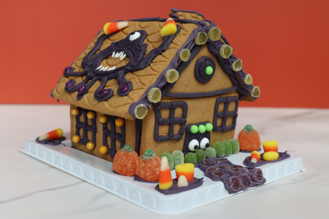 Halloween gingerbread haunted house cookie decorating, a live-hosted virtual team building experience. Kits ship free in the U.S.
