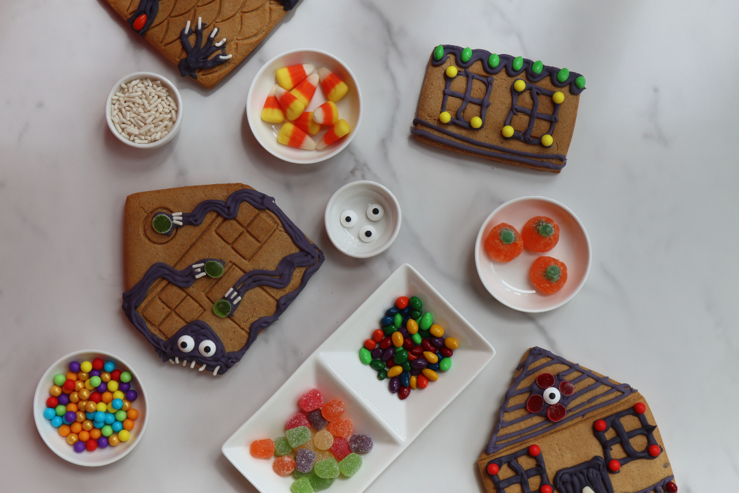Halloween gingerbread haunted house cookie decorating, a live-hosted virtual team building experience. Kits ship free in the U.S.