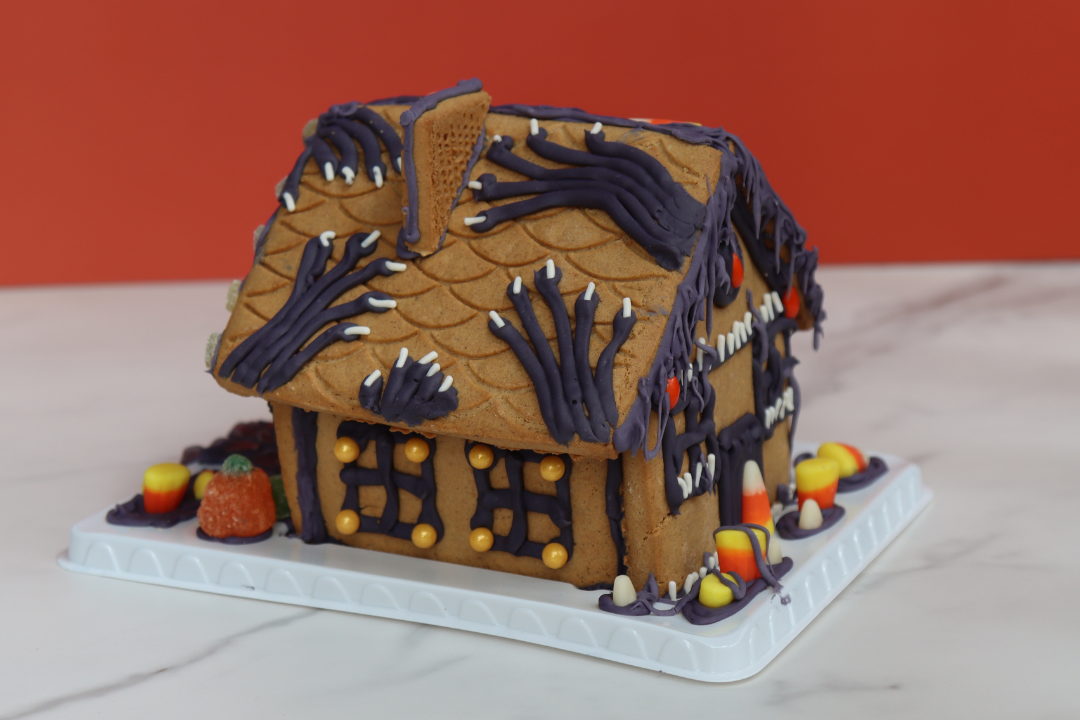 Halloween gingerbread haunted house cookie decorating, a live-hosted virtual team building experience. Kits ship free in the U.S.