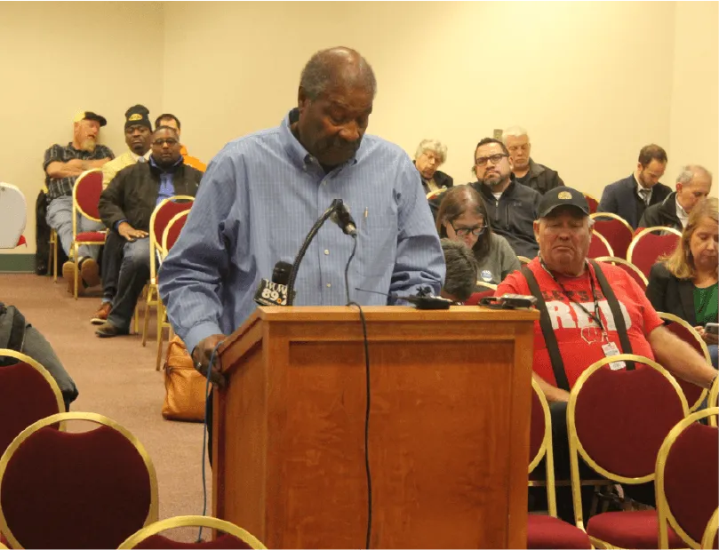 A group of people in the Milwaukee Marriott ballroom on August 1, 2023 for the public involvement meeting. Some individuals are writing down their comments while standing at high top tables.