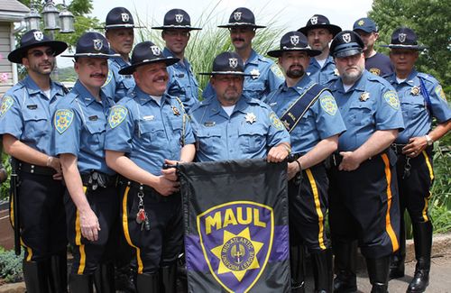 MAUL Officers holding banner