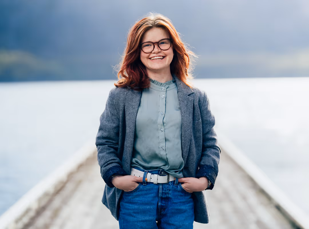 Bedriftsfoto Stavanger – ansattportrett av kvinne i blazer på brygge, profesjonell bedriftsfotografering utendørs.