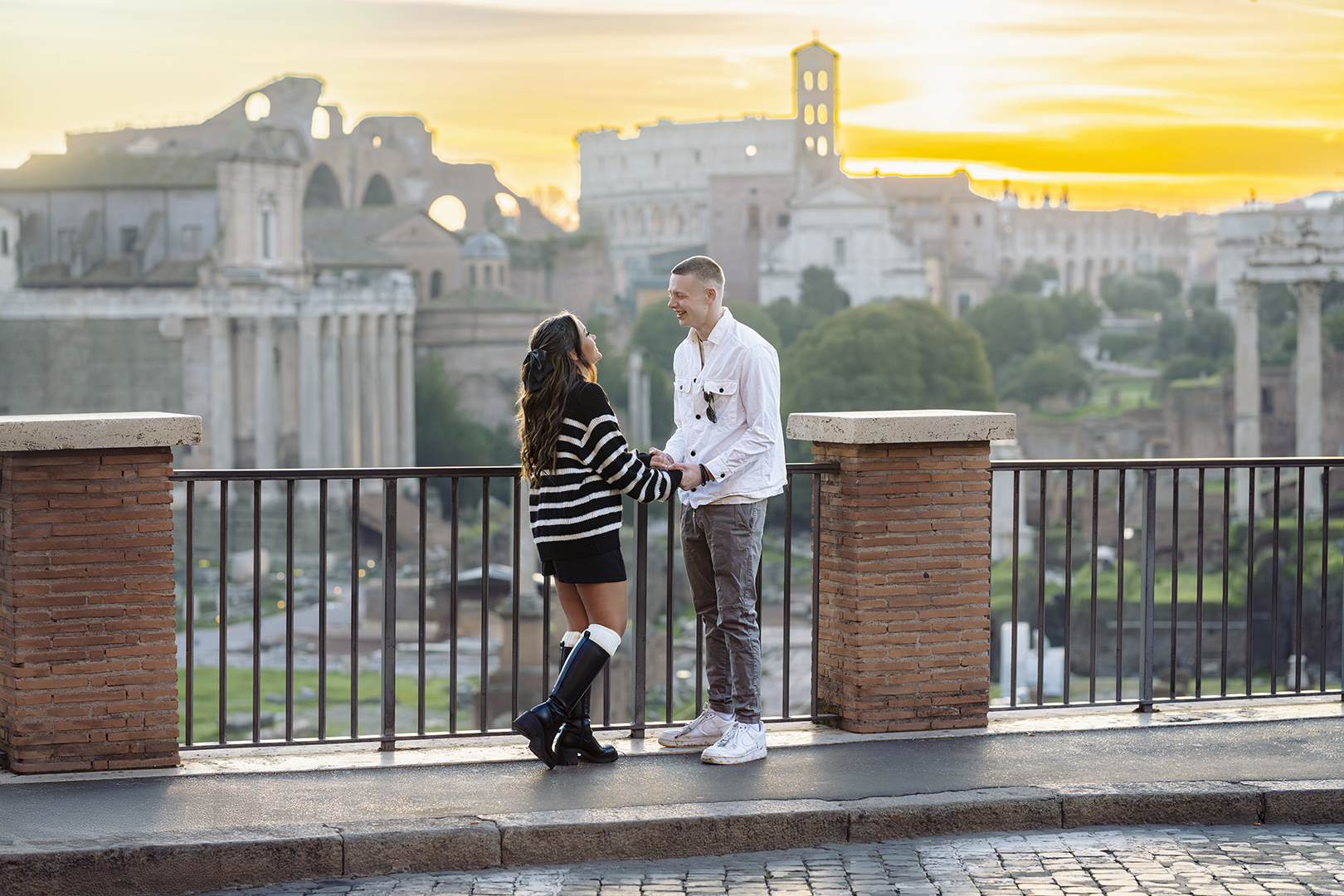 Couple at sunset on Capitoline Hill, overlooking the Roman Forum during an editorial photoshoot in Rome.