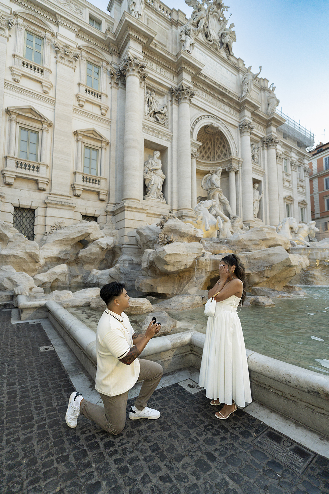 Surprise marriage proposal at Trevi Fountain in Rome, captured by Eidos Photography with an emotional reaction from the bride-to-be.