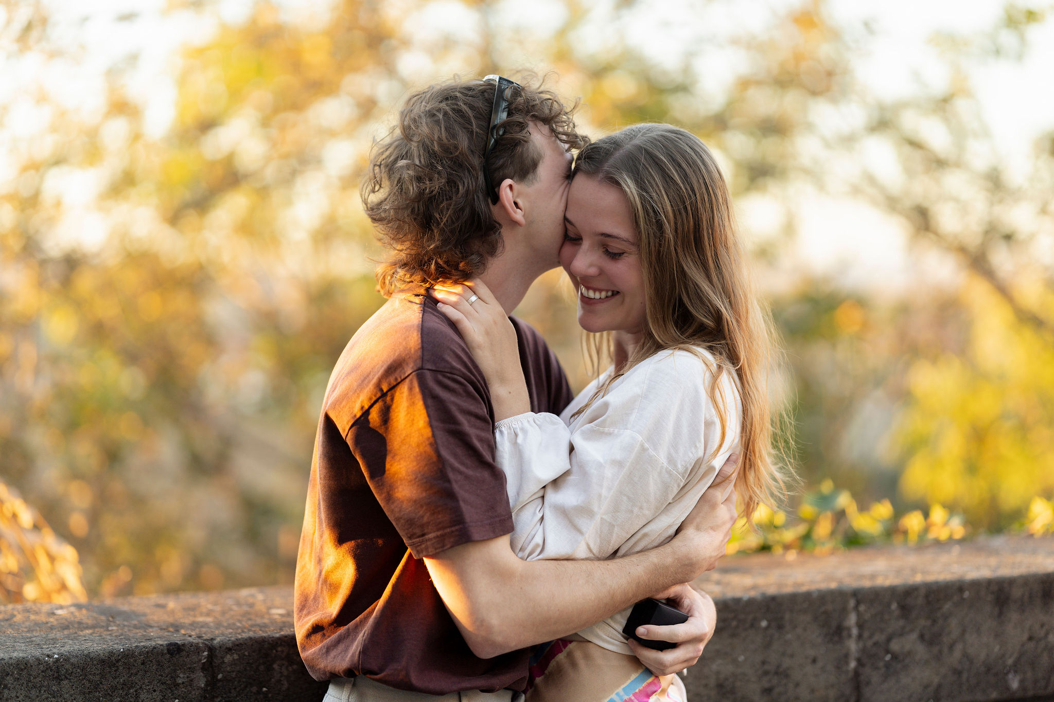 Close up of a couple hugging at sunset on Aventine Hill in Rome after a secret proposal photoshoot, captured by Eidos Photography Rome photographer