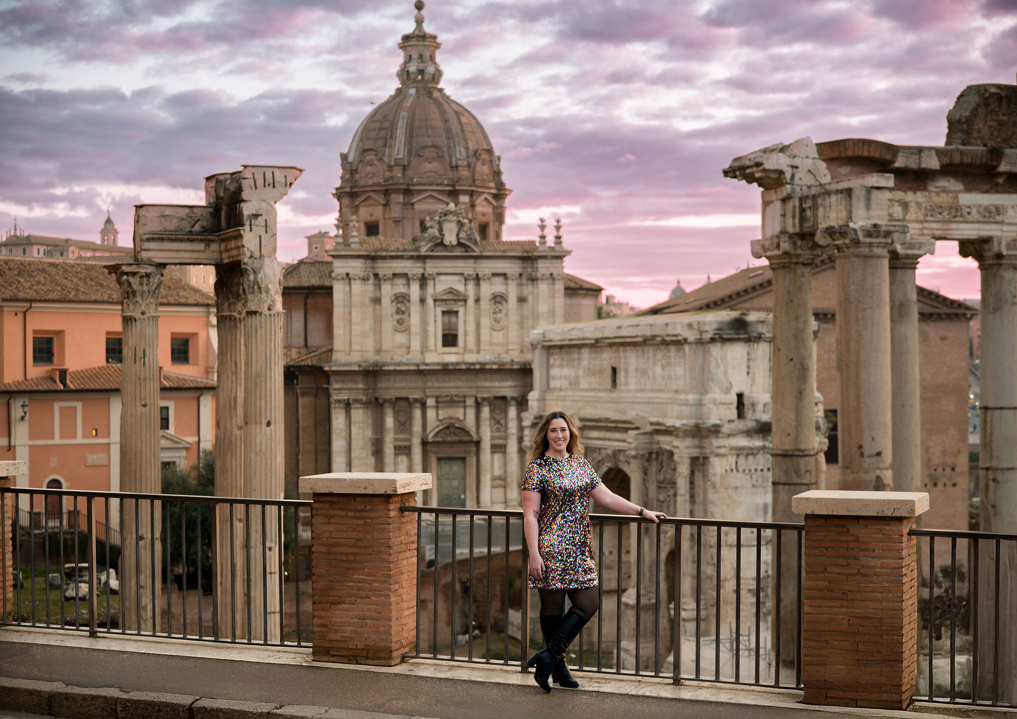 Portrait at the Roman Forum viewpoint with historic columns and church dome at sunset, showing balanced highlights, shadow detail, and natural HDR rendering.