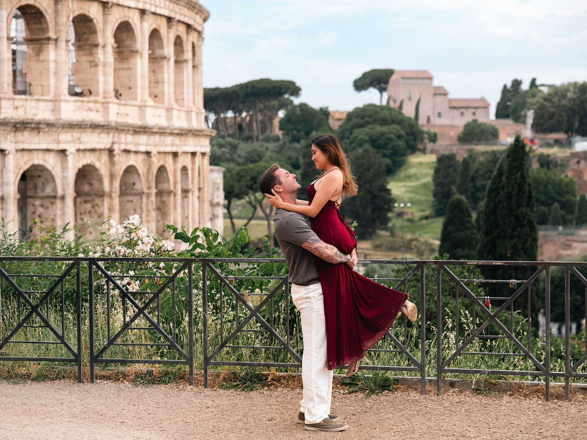 Couple posing at Giardinetto del Monte Oppio with a hidden Colosseum view during a secret proposal photoshoot in Rome.