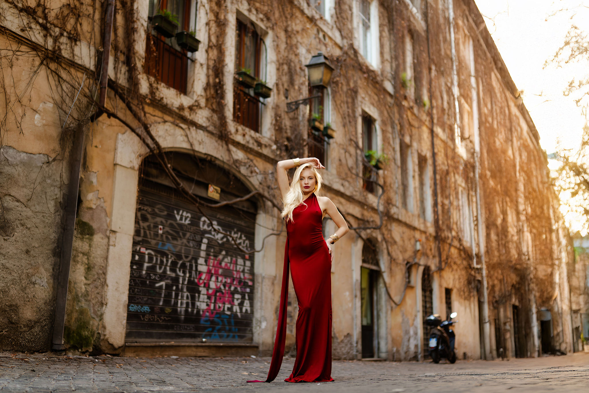 Fashion portrait in a red dress by Fontana di San Simeone in Rome
