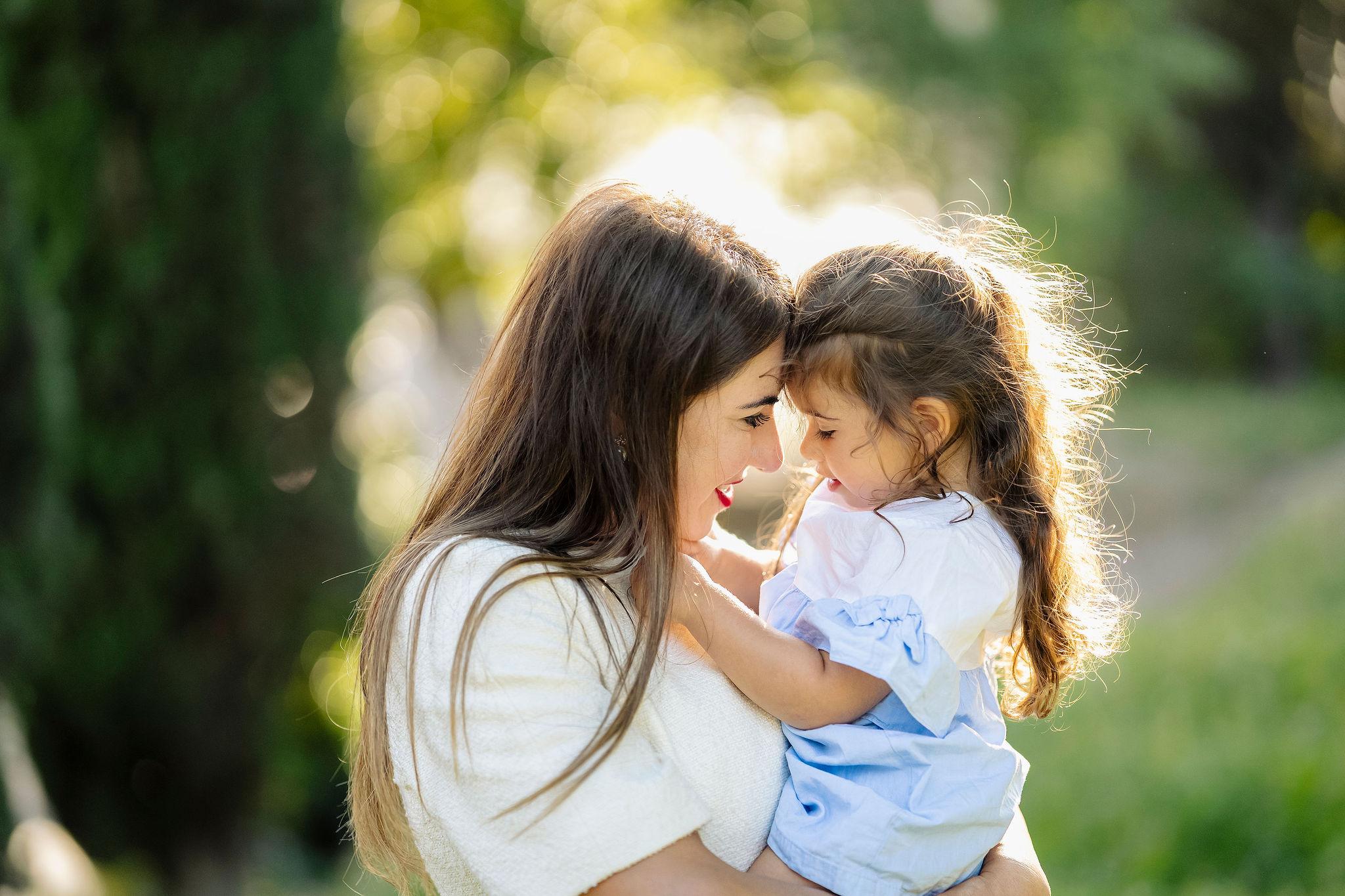Mother holding her young daughter during a warm, candid family photoshoot in Rome.