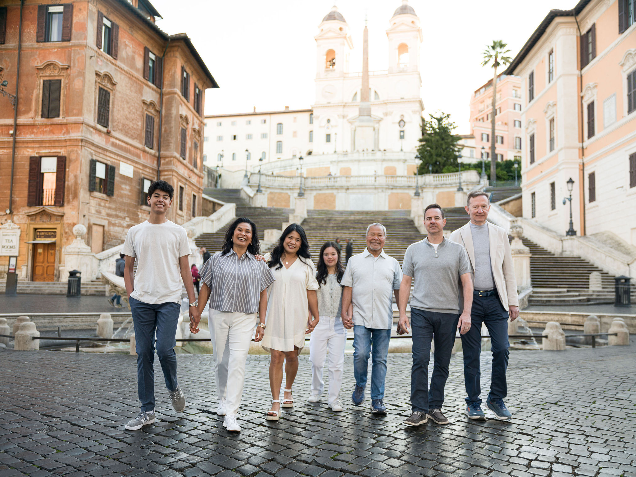 Multi-generational family walking together near the Spanish Steps in Rome during a relaxed family photoshoot.