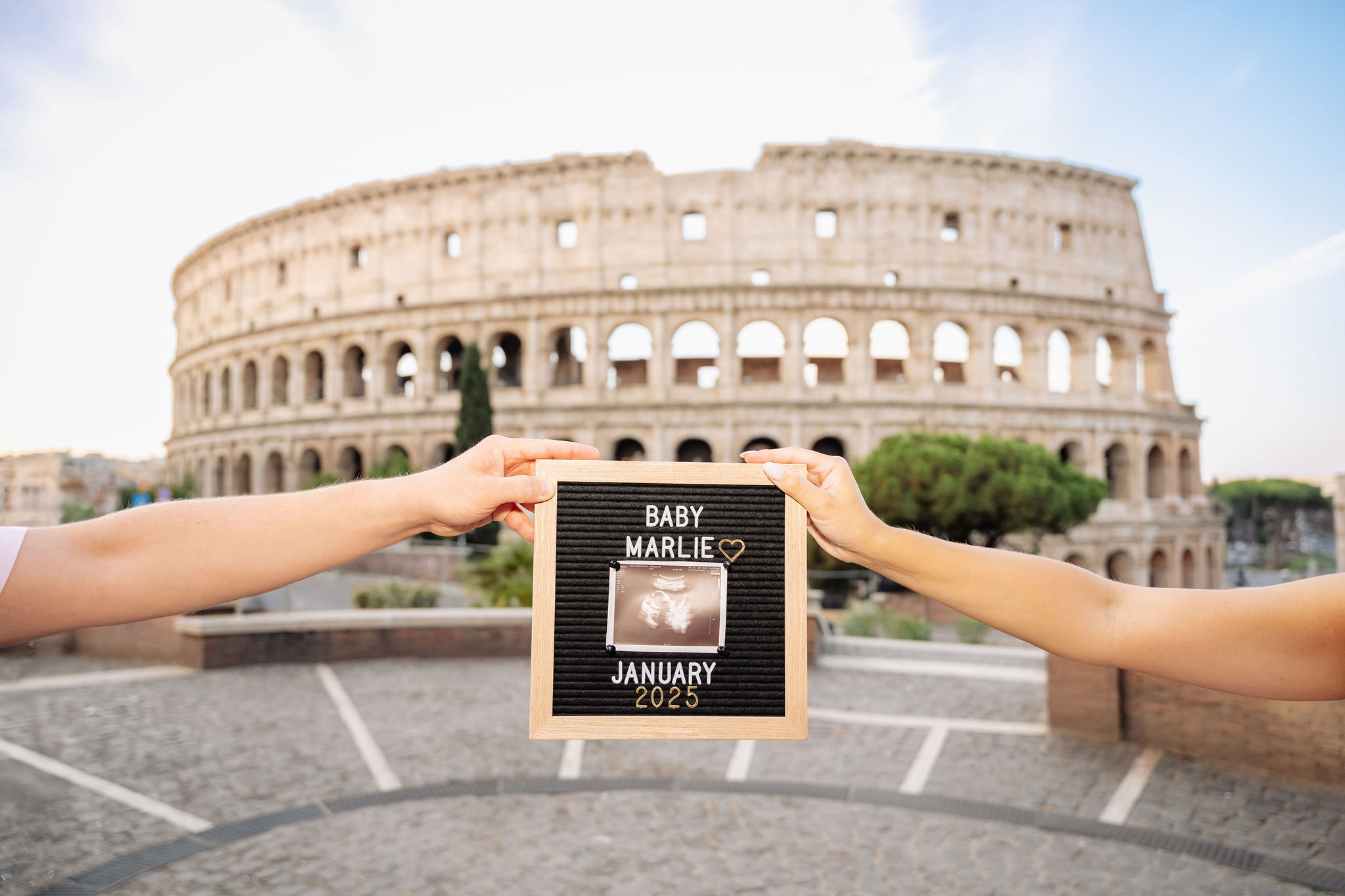     Couple gently holding the baby bump during a comfortable maternity photoshoot in Rome.