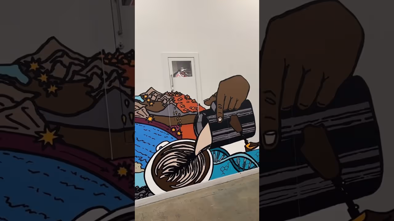 Mural of a hand pouring coffee into a cup with swirling latte art and colorful shapes on a wall.