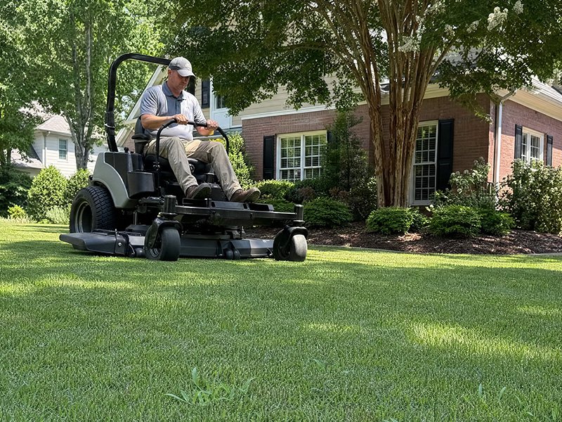 person mowing lawn